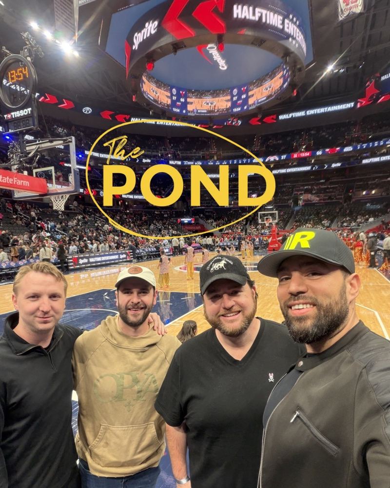 Members at a basketball game with The Pond on the big screen