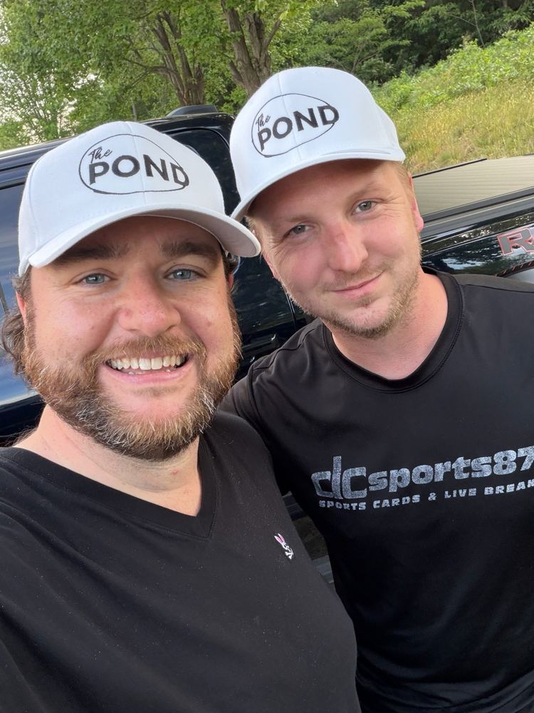 Two members wearing The Pond hats